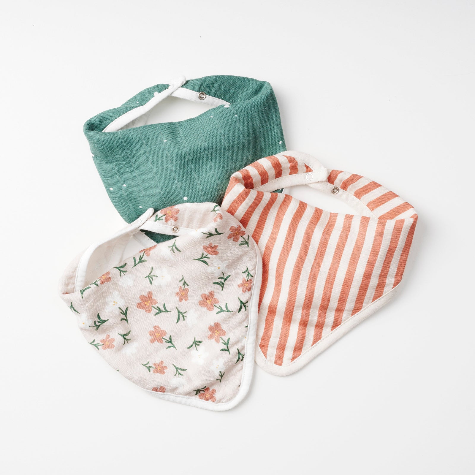 Three baby bibs with different patterns on a white background